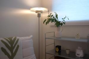 a room with a lamp and a vase with a plant at Red letter day #Dongdaemun #Seongsu #Hanyangdae #Ttukseom #SubwayStreet 5 minutes #netflix #emotional #legalhome in Seoul