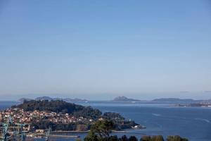 a small island in the middle of a body of water at Gran casa con vistas a la ría de Vigo in Vigo