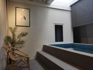 a waiting room with a chair and a tub at Heritage House 2BR with Dipping Pool in Town walkto Street Art 45 in George Town