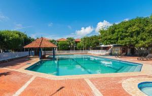 a swimming pool with a gazebo in a yard at Hermosa Cabana con Piscina 3 Habitaciones MC21 in Coveñitas +12 photos