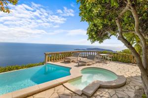 a pool with a view of the ocean at La Chèvre d'Or in Éze