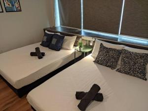 two beds in a room with crosses on them at Heritage House 2BR in Town walkto UNESCO Site & StreetArt 45 in George Town