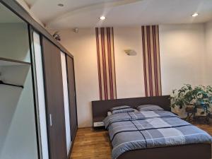 a bedroom with a bed with a blue blanket at Panoramic Apartment in Târgu-Mureş