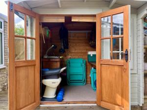 a bathroom with a toilet inside of a house at Leaze Garden Cottage - Frome in Frome +22 photos