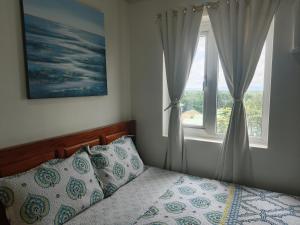 Voodi või voodid majutusasutuse Happy Stays A - Sunset View at SMDC Hope Residences toas