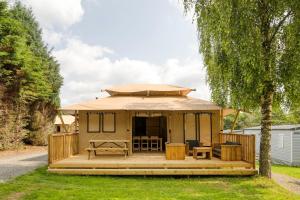 a tiny house with a porch and a deck at Arden Parks Signy l'Abbaye in Signy-lʼAbbaye