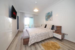 a bedroom with a bed and a tv on a wall at La Siesta Beach Resort in Mohammedia