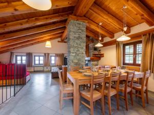 a dining room with a wooden table and chairs at Chalet Casot Brusa by Interhome in Sampeire