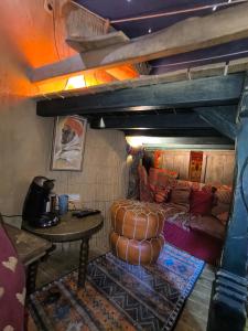 a living room with a couch and a table at La Balade des Gnomes in Durbuy +18 photos