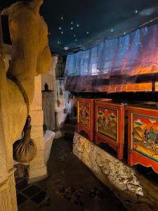 a room with two tables with paintings on it at La Balade des Gnomes in Durbuy
