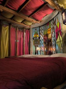 a bedroom with a bed with a stained glass window at La Balade des Gnomes in Durbuy +18 photos