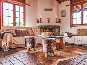 a living room with a couch and a fireplace at Chalet La Couronne by Interhome in Nendaz
