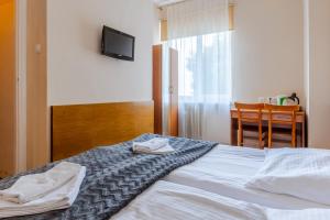 Postel nebo postele na pokoji v ubytování Hotel Dom Marynarza