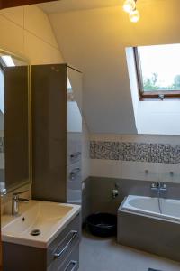 a bathroom with a sink and a tub and a window at Ostoja w Górach in Bieńkówka +28 photos