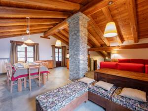 a living room with a red couch and a table at Chalet Casot Pra La Funt by Interhome in Sampeire