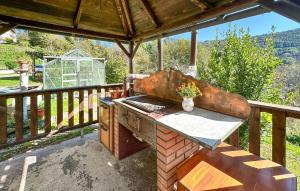 an outdoor grill sitting on a patio on a deck at Lovely Apartment In Lamon With Wifi in Lamon