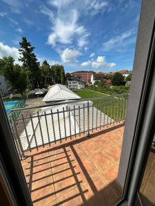 a view from a window of a patio with a fence at Apartman Vidić 2 in Požega