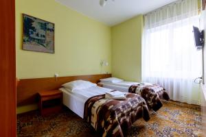 Postel nebo postele na pokoji v ubytování Hotel Dom Marynarza
