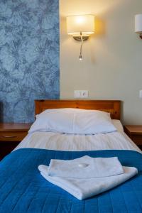 Postel nebo postele na pokoji v ubytování Hotel Dom Marynarza