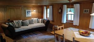a living room with a couch and a table at Ferienhaus-Bregenzerwald in Bizau