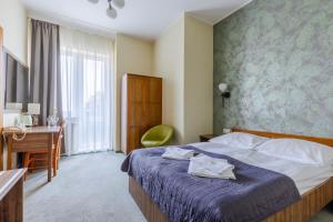 Postel nebo postele na pokoji v ubytování Hotel Dom Marynarza