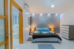 a bedroom with a large bed and a bathroom at New Spacious Apartment 3 Bdr 2 Bth Bugibba 124 with View in St Paul's Bay