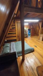 a room with a bed in the middle of a attic at tropical garden homestay in Lien Khuong Airport