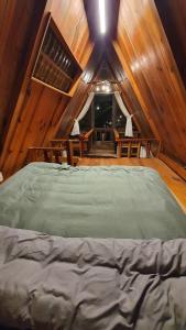 a bedroom with a bed in a wooden cabin at tropical garden homestay in Lien Khuong Airport