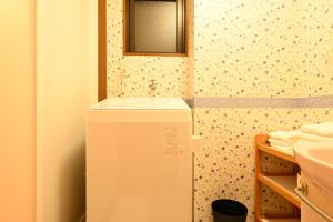 a white refrigerator in a bathroom with a mirror at Peace & Harmony 1 in Nagoya
