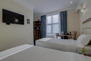 Postel nebo postele na pokoji v ubytování Hotel Resident Bishkek