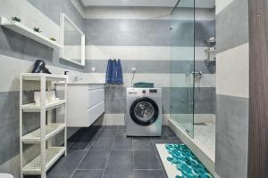 a washing machine in a bathroom with a shower at La Siesta Beach Resort in Mohammedia +12 photos