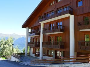 a building with balconies on the side of it at Courchevel: Skis aux pieds, 3 ch, Wifi, Parking, 4 pers - FR-1-575-24 in Courchevel