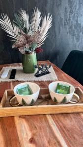 a wooden tray with three bowls on a table at Апартамент - Боровец Хотел ''Боровец Гардънс'' A 44 in Borovets