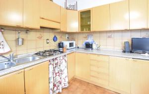 a kitchen with a sink and a stove top oven at Lovely Apartment In Lamon With Wifi in Lamon
