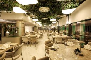 a dining room with tables and chairs and ceilings at Four Hills Hotel in Antalya