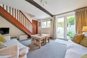 a living room with a couch and a table at Apple Cottage - Central Frome - Outdoor Space in Frome