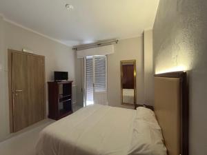 Postel nebo postele na pokoji v ubytování Hotel Ristorante StellAmiata