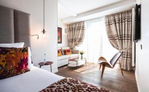 a bedroom with a bed and a living room at Hotel & Spa REGENT PETITE FRANCE By Stay Collection in Strasbourg