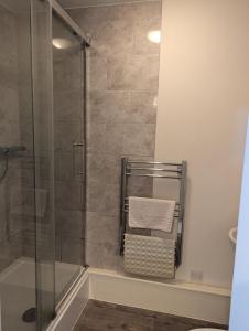 a bathroom with a shower with a glass door at Railway Inn in Culham +54 photos