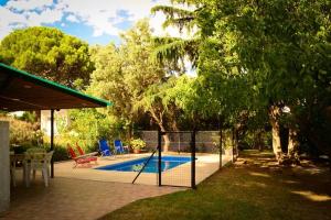 a swimming pool in a backyard with a swing at La Casita del Golf in Sierra de la Ventana