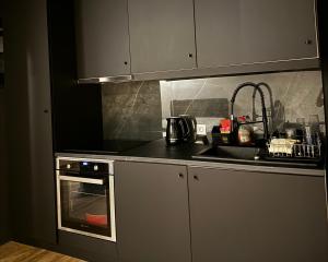 a kitchen with a sink and a stove at Mazzo luxury Monemvasia in Monemvasia