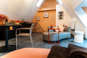 a living room with a couch and a table at Les toits de la Citadelle in Belfort