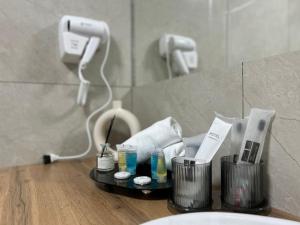 a bathroom with a counter with hygiene products on it at Manas Apartments in Qyzylorda