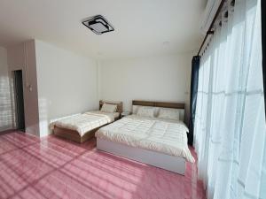 Postel nebo postele na pokoji v ubytování Mali house Hatyai