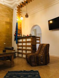 a living room with a couch and a table at Dar Chahla in Tozeur
