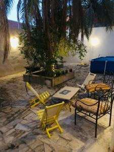 a group of chairs and tables on a stone patio at Dar Chahla in Tozeur