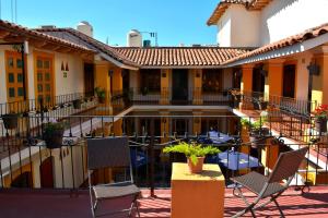 a balcony of a house with chairs and a table at Hotel Aldama in Colima