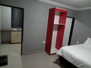 Ένα ή περισσότερα κρεβάτια σε δωμάτιο στο Elangeni Guest House