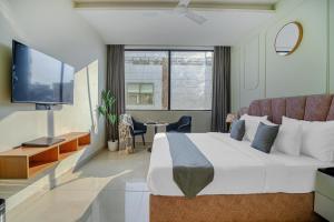 a hotel room with a large bed and a tv at HOTEL SKY VIEW - Zirakpur, Chandigarh in Zirakpur