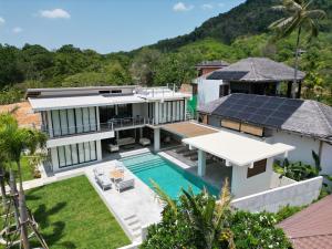 an aerial view of a house with a solar roof at ANDAMAN Villa KOH YAO NOI in Ko Yao Noi